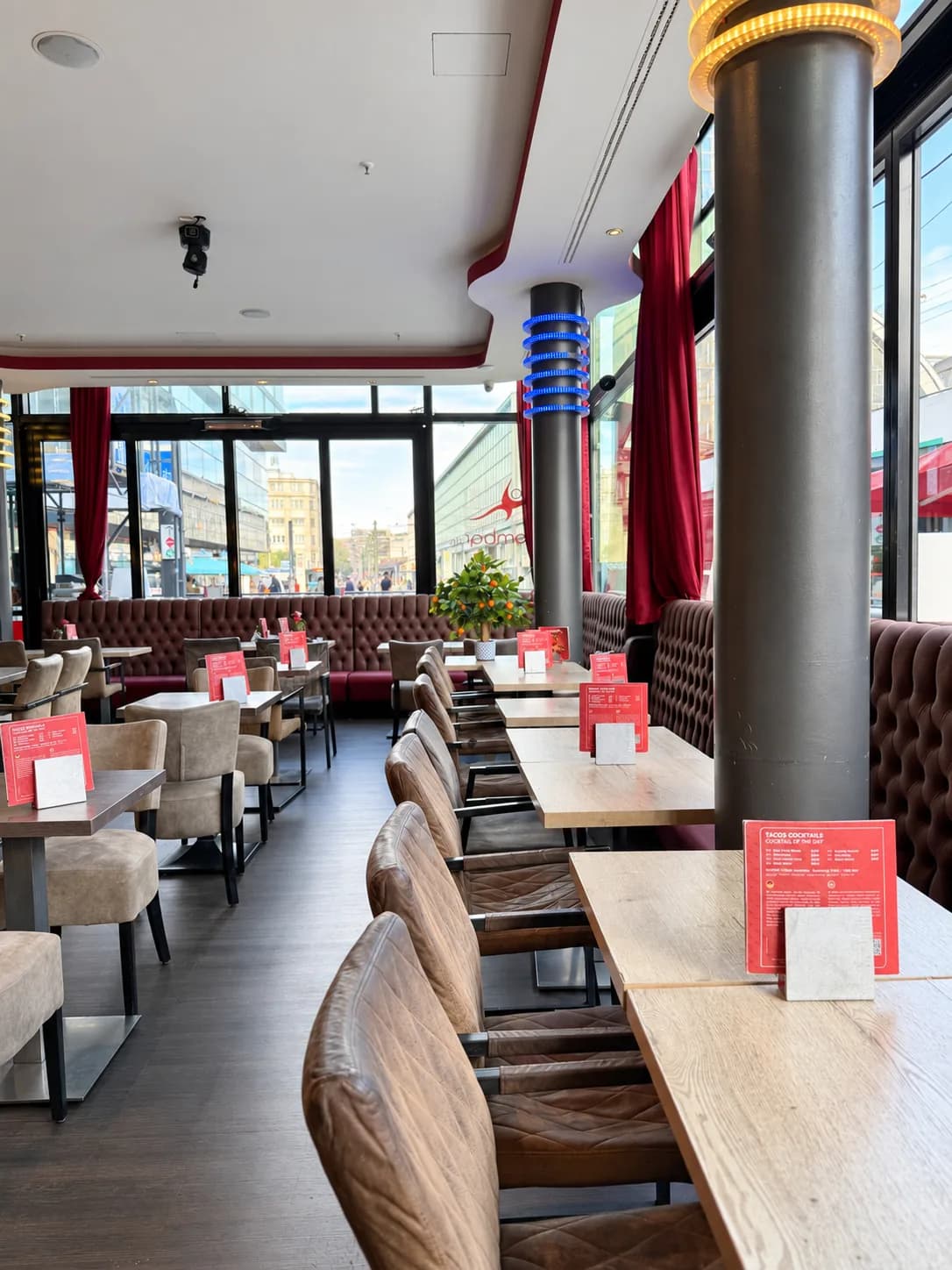 Row of tables by the window at Carambar overlooking Alexanderplatz